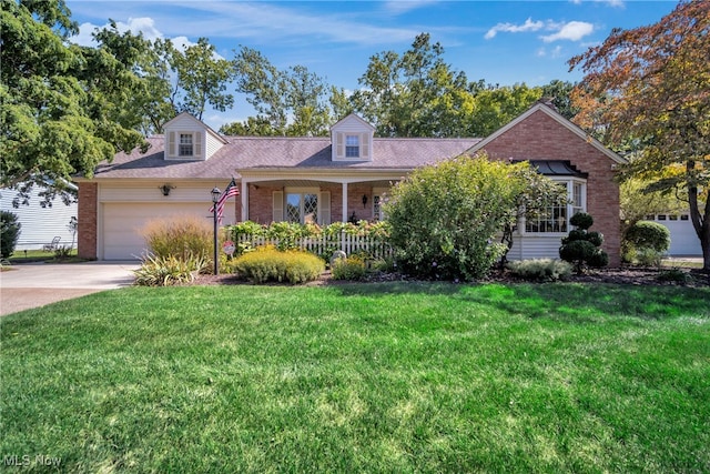 cape cod-style house featuring a garage and a front lawn