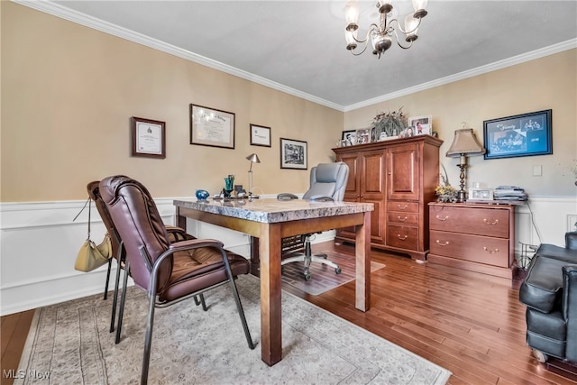 home office with hardwood / wood-style flooring, a chandelier, and ornamental molding