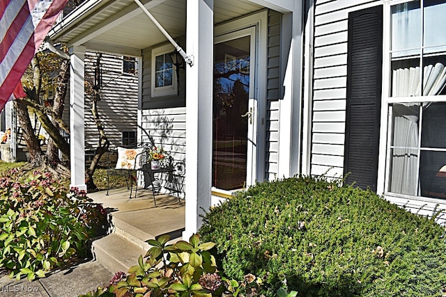 view of exterior entry featuring a porch