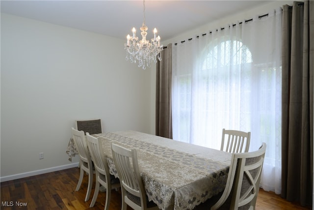 dining room with a notable chandelier and dark hardwood / wood-style floors