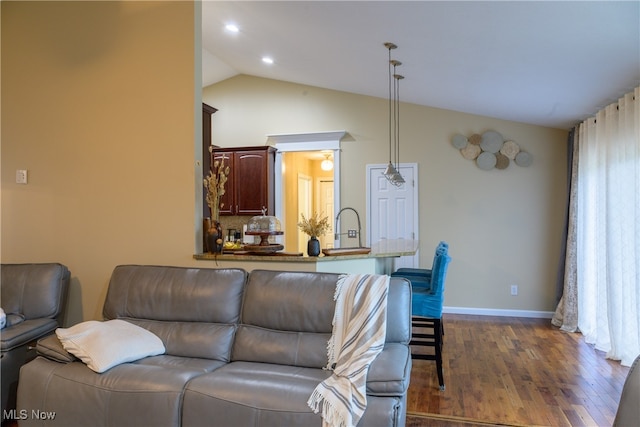 living room featuring dark wood-type flooring, lofted ceiling, and sink