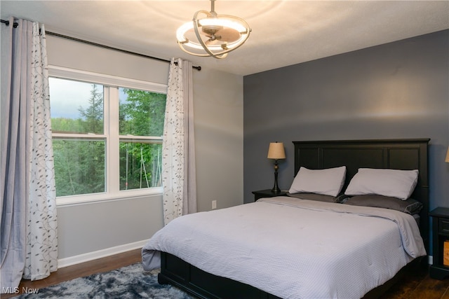 bedroom featuring multiple windows and dark hardwood / wood-style floors