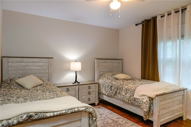 bedroom featuring multiple windows, ceiling fan, and dark hardwood / wood-style flooring