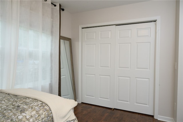 bedroom featuring a closet and dark hardwood / wood-style flooring