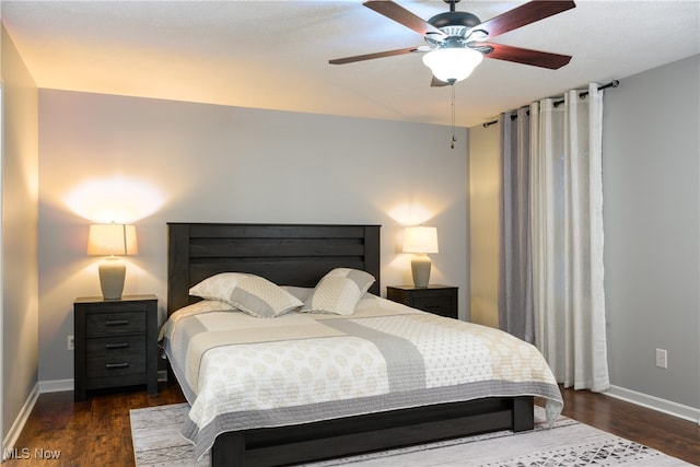 bedroom with ceiling fan and dark hardwood / wood-style floors