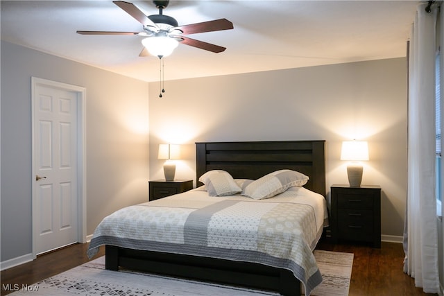 bedroom with ceiling fan and dark hardwood / wood-style flooring