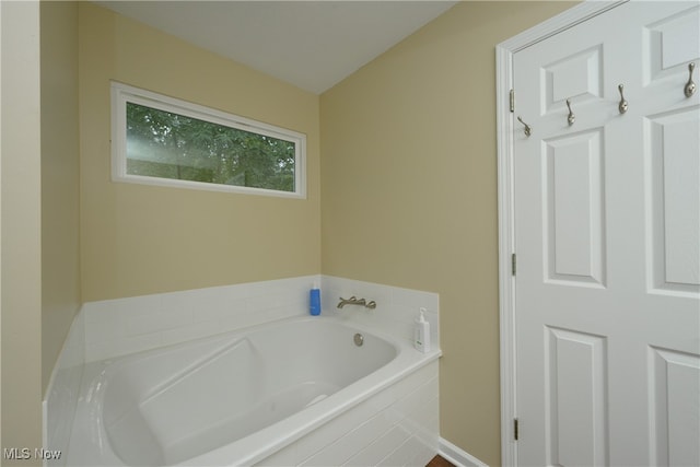 bathroom with a relaxing tiled tub