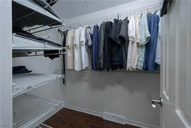 spacious closet with dark hardwood / wood-style floors