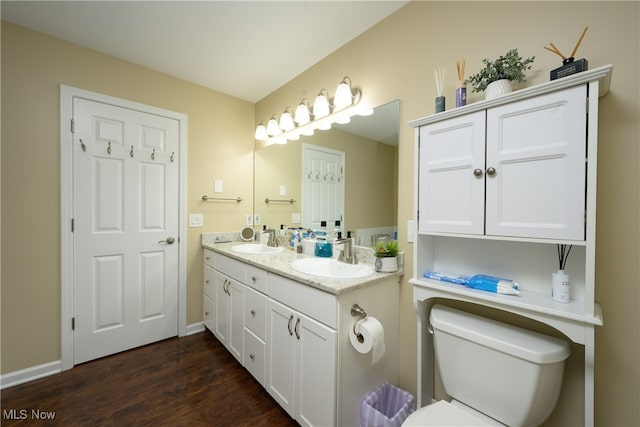 bathroom featuring vanity, toilet, and wood-type flooring