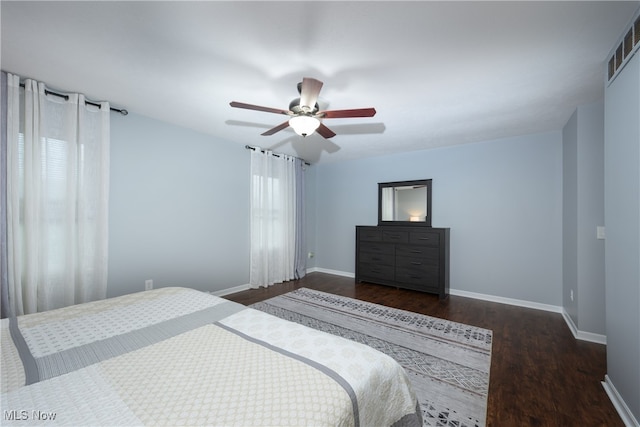 bedroom with ceiling fan and dark hardwood / wood-style flooring