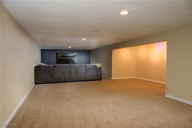 unfurnished living room featuring light carpet and a textured ceiling