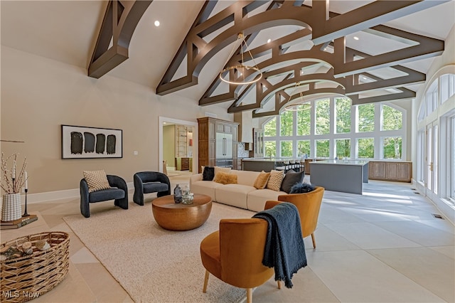 tiled living room featuring an inviting chandelier, beam ceiling, and high vaulted ceiling