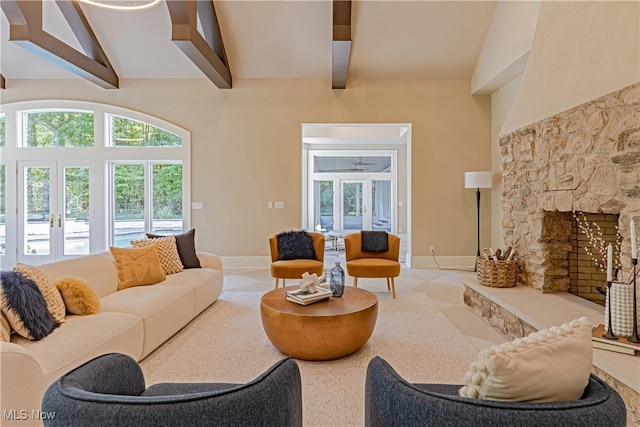 living room featuring light tile patterned floors, a fireplace, high vaulted ceiling, and beamed ceiling