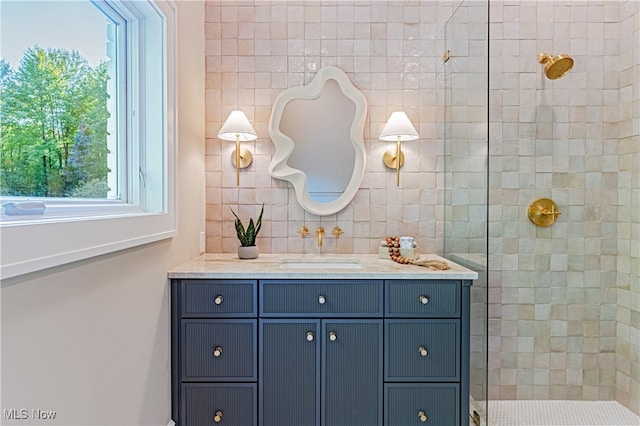 bathroom with vanity and tiled shower