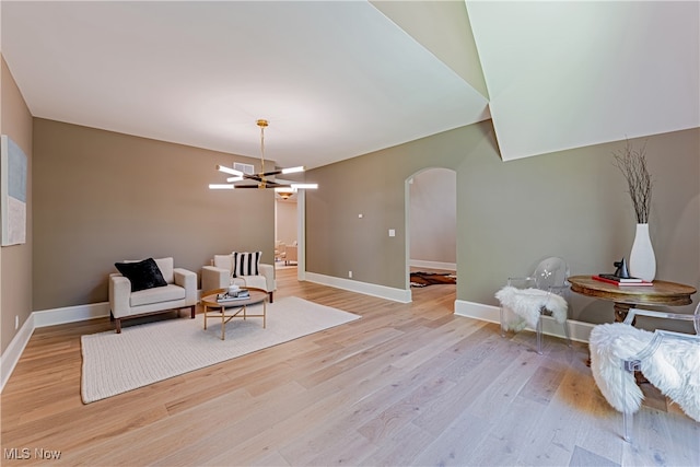 sitting room with an inviting chandelier and light hardwood / wood-style flooring