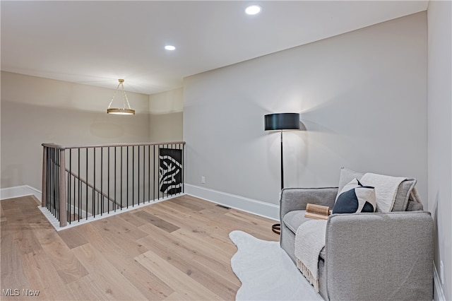 sitting room with hardwood / wood-style flooring