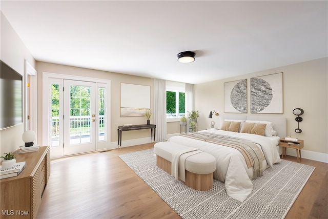 bedroom featuring access to exterior and light hardwood / wood-style floors