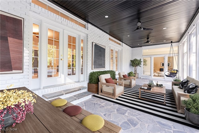 sunroom with ceiling fan, wood ceiling, and french doors