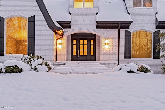 view of snow covered property entrance