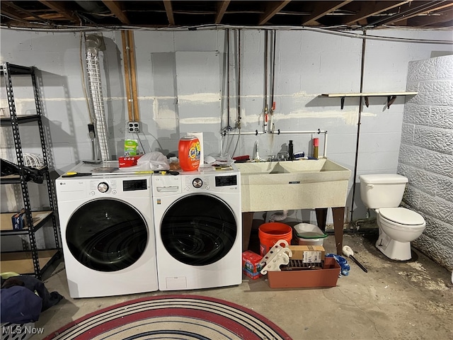 laundry area featuring washer and clothes dryer and sink