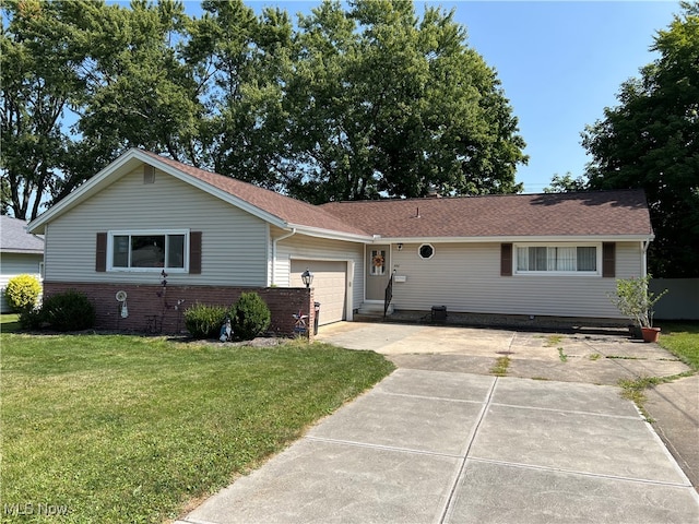 ranch-style home with a front lawn and a garage