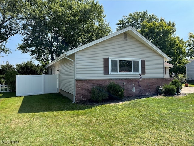 view of home's exterior with a lawn