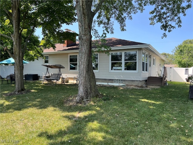 rear view of property with a yard