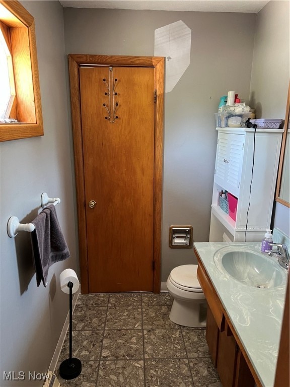 bathroom featuring toilet and vanity