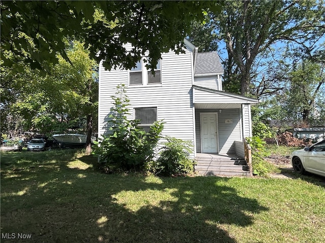 view of side of property with a lawn