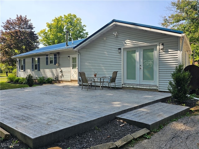 back of house featuring french doors and a deck