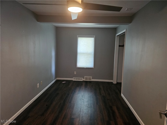 empty room featuring ceiling fan and dark hardwood / wood-style floors