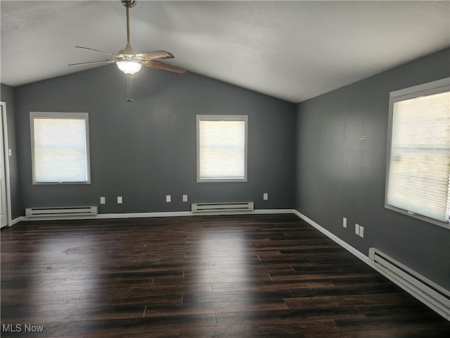 empty room featuring ceiling fan, baseboard heating, and plenty of natural light