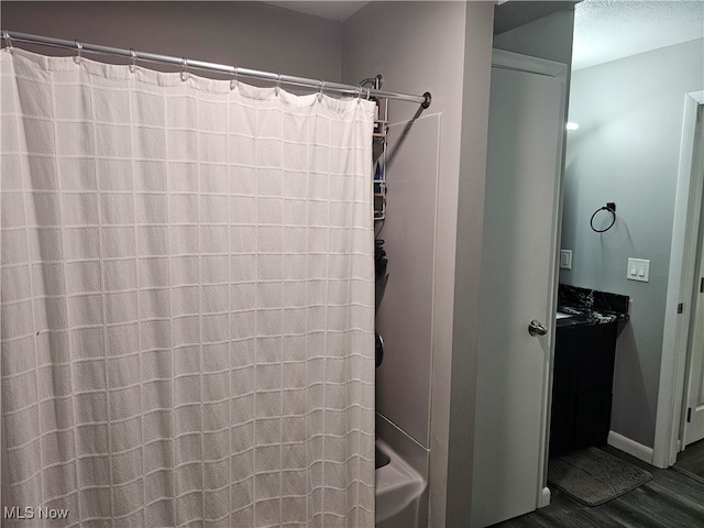 bathroom with shower / bath combo with shower curtain