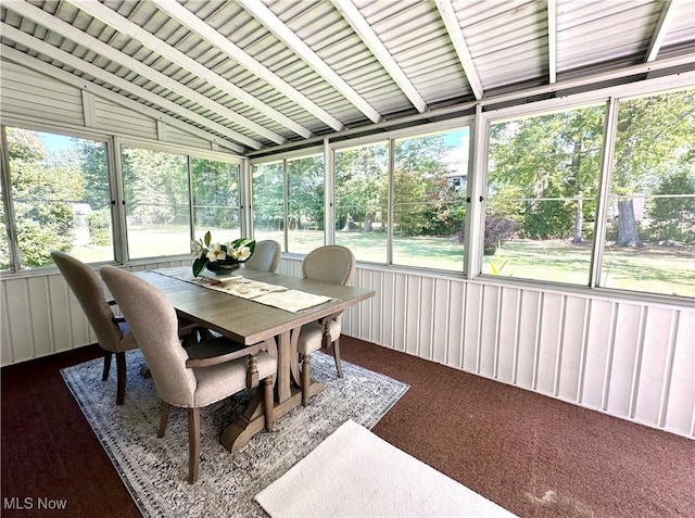 sunroom / solarium featuring plenty of natural light and lofted ceiling with beams