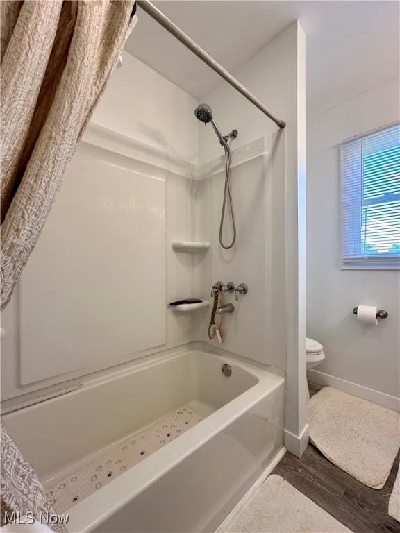 bathroom with hardwood / wood-style flooring and toilet