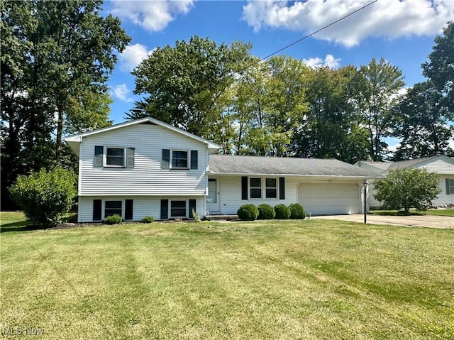 tri-level home featuring a garage and a front yard