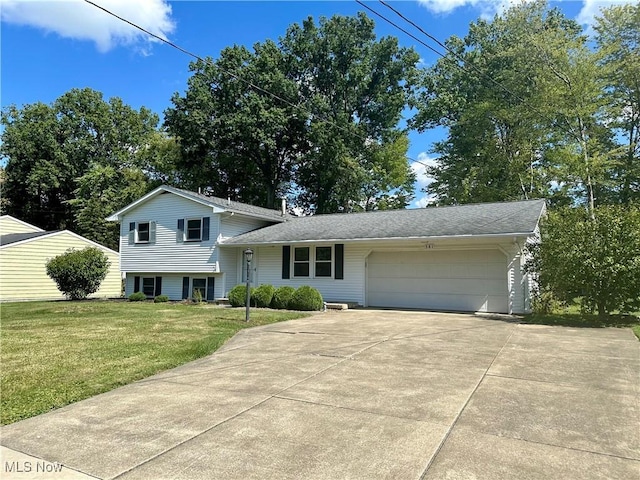 split level home featuring a garage and a front yard