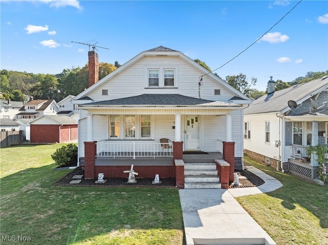 2110 Commerce St, Wellsburg, WV 26070 - bungalow-style home featuring a front lawn, a chimney, fence, covered porch, and a shingled roof