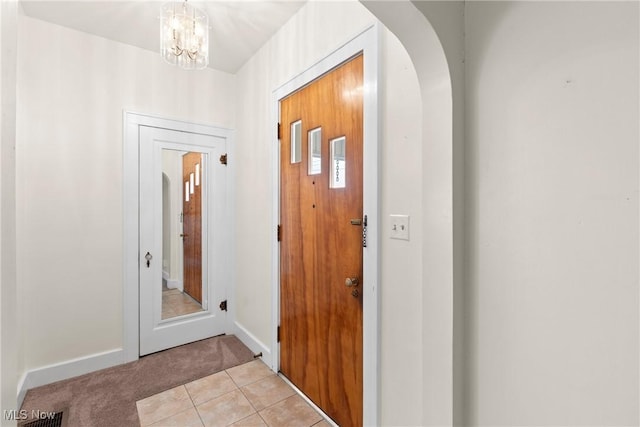 2110 Commerce St, Wellsburg, WV 26070 - foyer entrance with an inviting chandelier, visible vents, arched walkways, baseboards, and light colored carpet