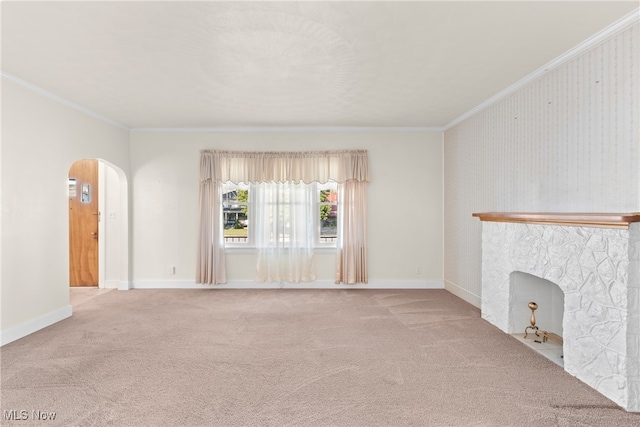 unfurnished living room with ornamental molding and carpet