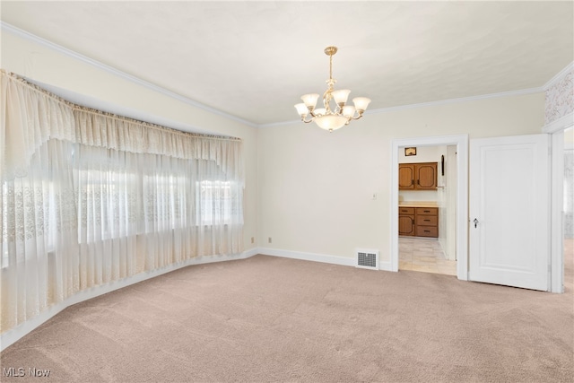 spare room with ornamental molding, light colored carpet, and an inviting chandelier