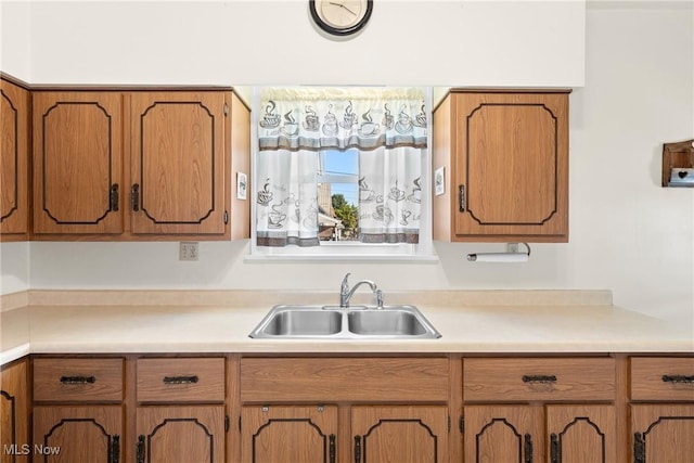 2110 Commerce St, Wellsburg, WV 26070 - kitchen with brown cabinets, a sink, and light countertops