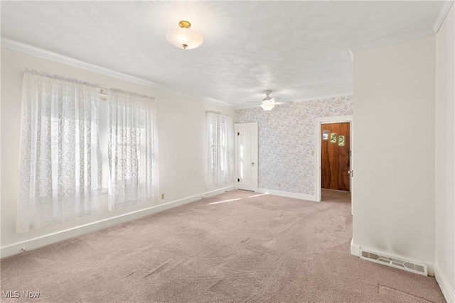 carpeted empty room with ceiling fan and ornamental molding