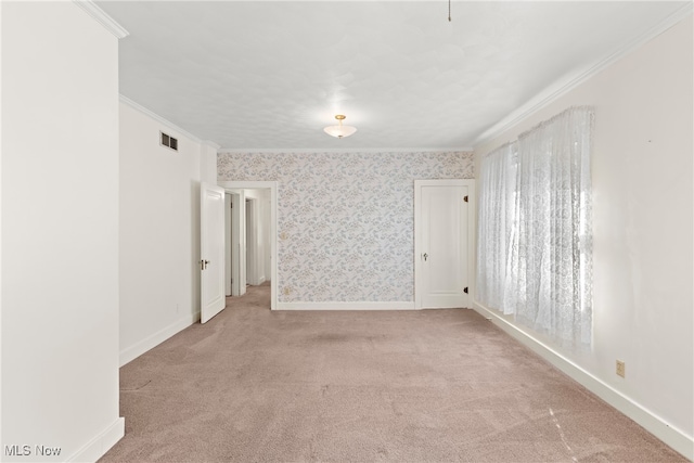 carpeted empty room featuring plenty of natural light and crown molding