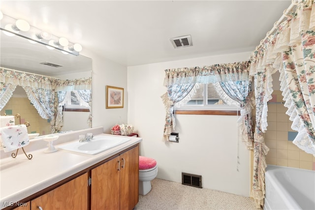 full bathroom with vanity, toilet, and separate shower and tub