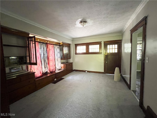 carpeted spare room featuring a textured ceiling and ornamental molding