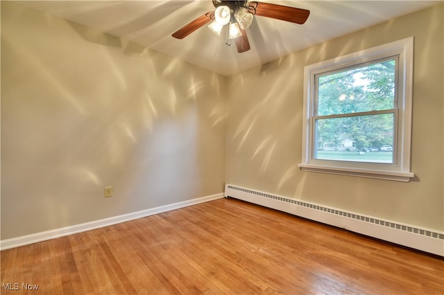 spare room with light hardwood / wood-style flooring, a baseboard radiator, and ceiling fan