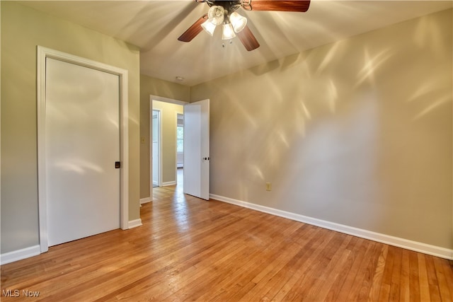 empty room with light wood-type flooring and ceiling fan