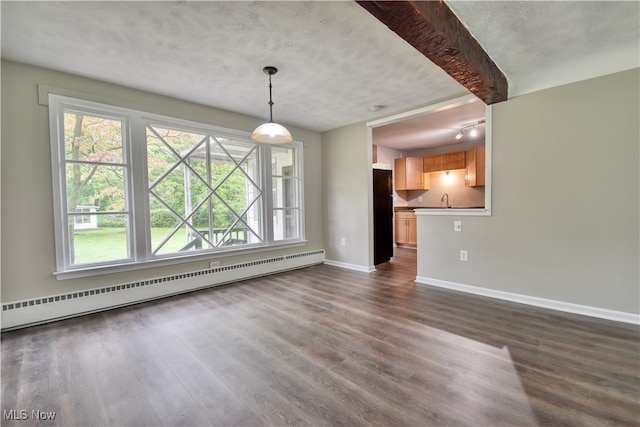 interior space with a baseboard heating unit, sink, dark wood-type flooring, beam ceiling, and a textured ceiling