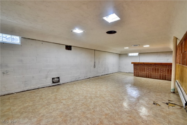 basement featuring a textured ceiling